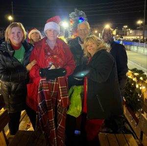 group of people dressed in coats on parade float